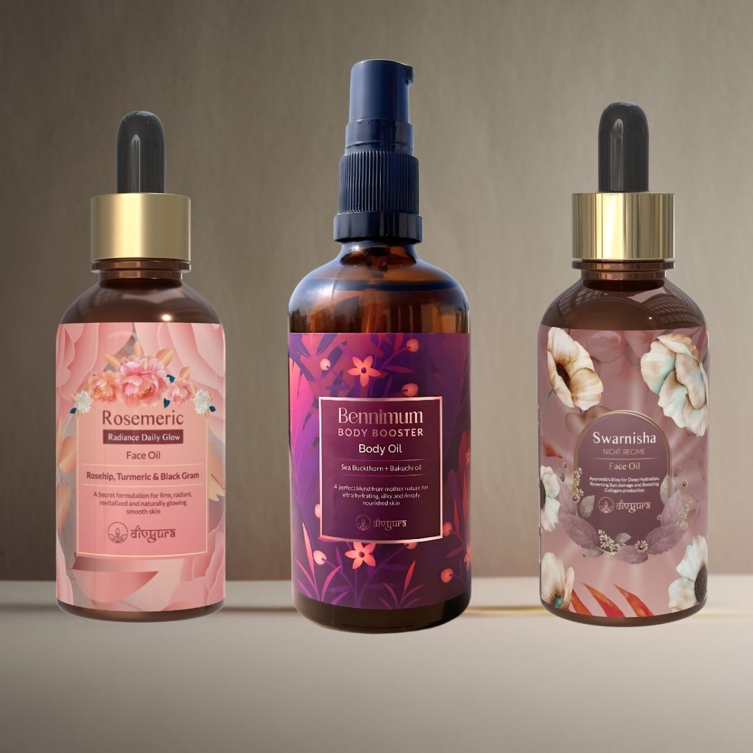 Three bottles of body and face oils with floral designs on labels against a neutral background